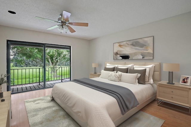 bedroom featuring a textured ceiling, hardwood / wood-style floors, ceiling fan, and access to exterior