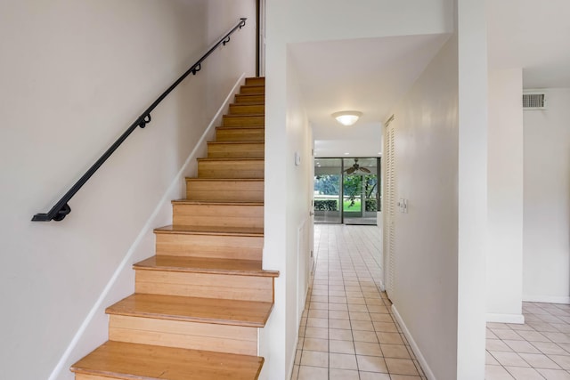 stairway featuring tile patterned flooring