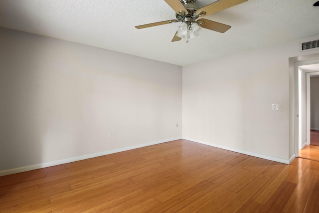 unfurnished room featuring ceiling fan, hardwood / wood-style floors, and a textured ceiling