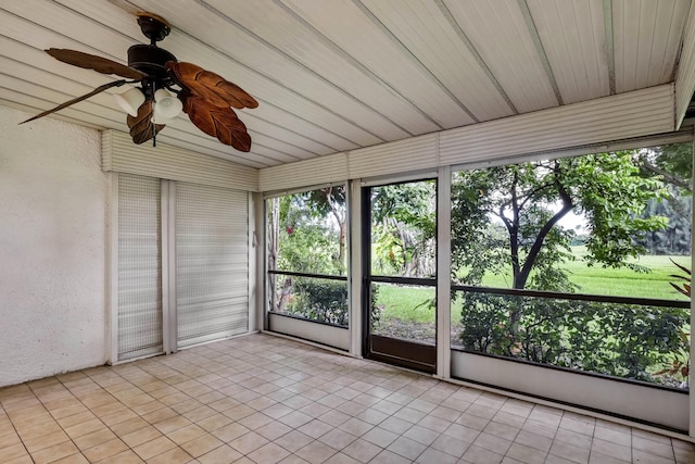 unfurnished sunroom featuring ceiling fan