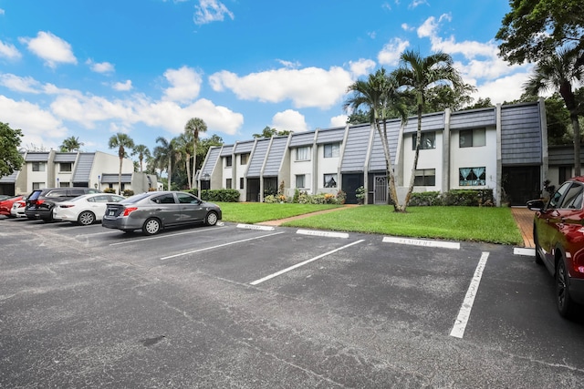 view of parking featuring a yard