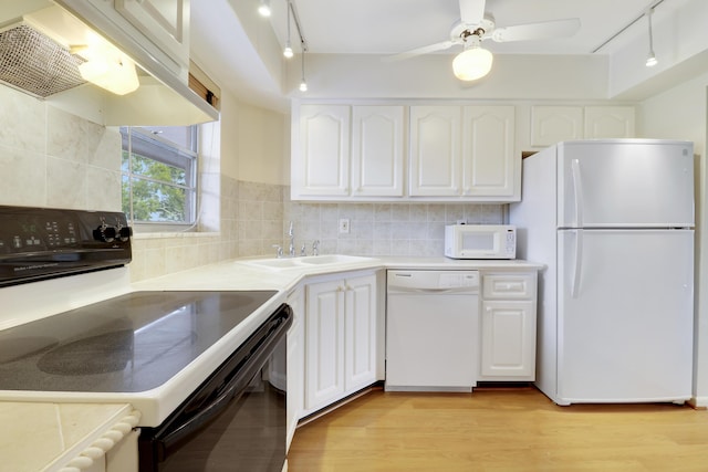 kitchen with ventilation hood, white cabinetry, tasteful backsplash, sink, and white appliances