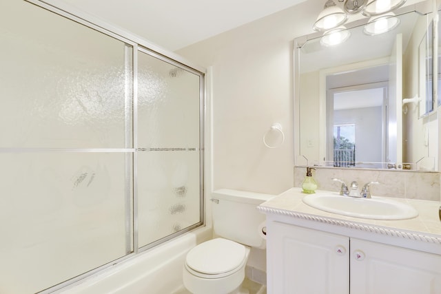 full bathroom with shower / bath combination with glass door, vanity, and toilet