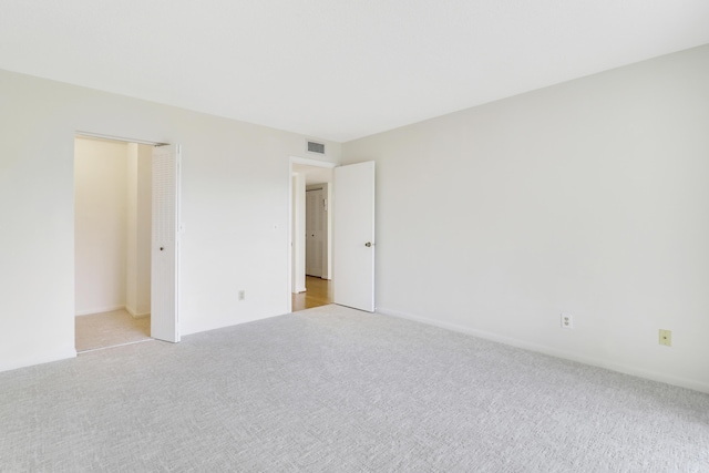 unfurnished bedroom featuring light colored carpet