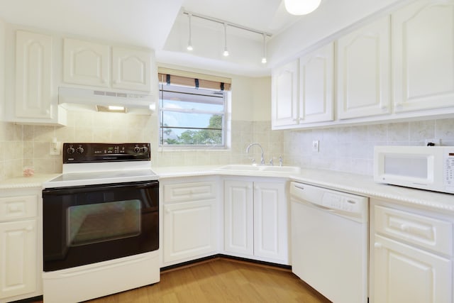 kitchen with white cabinetry, white appliances, sink, and light wood-type flooring