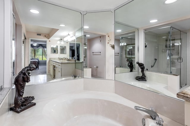 bathroom featuring vanity and separate shower and tub