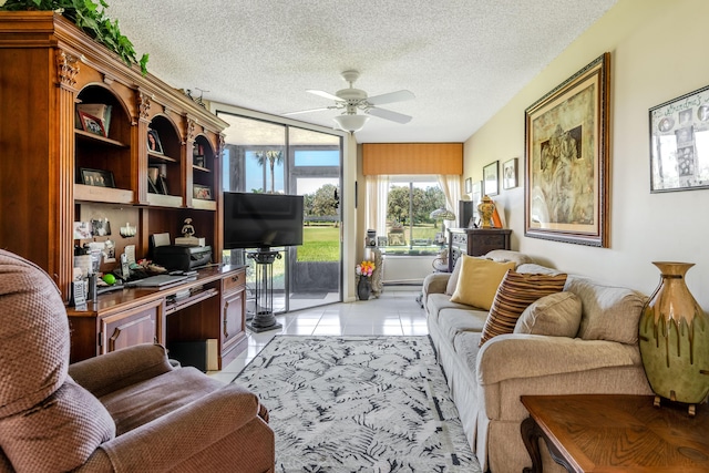 home office with light tile patterned flooring, ceiling fan, and a textured ceiling