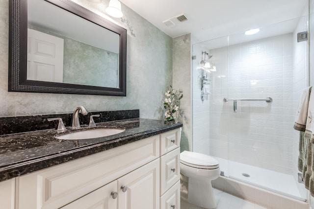 bathroom featuring vanity, toilet, tile patterned floors, and a shower with shower door