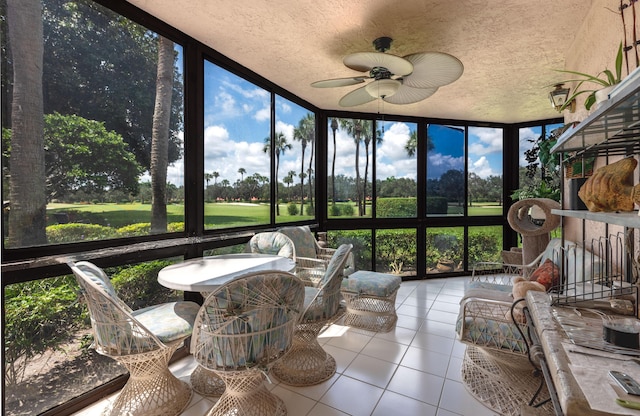 sunroom / solarium featuring a wealth of natural light and ceiling fan