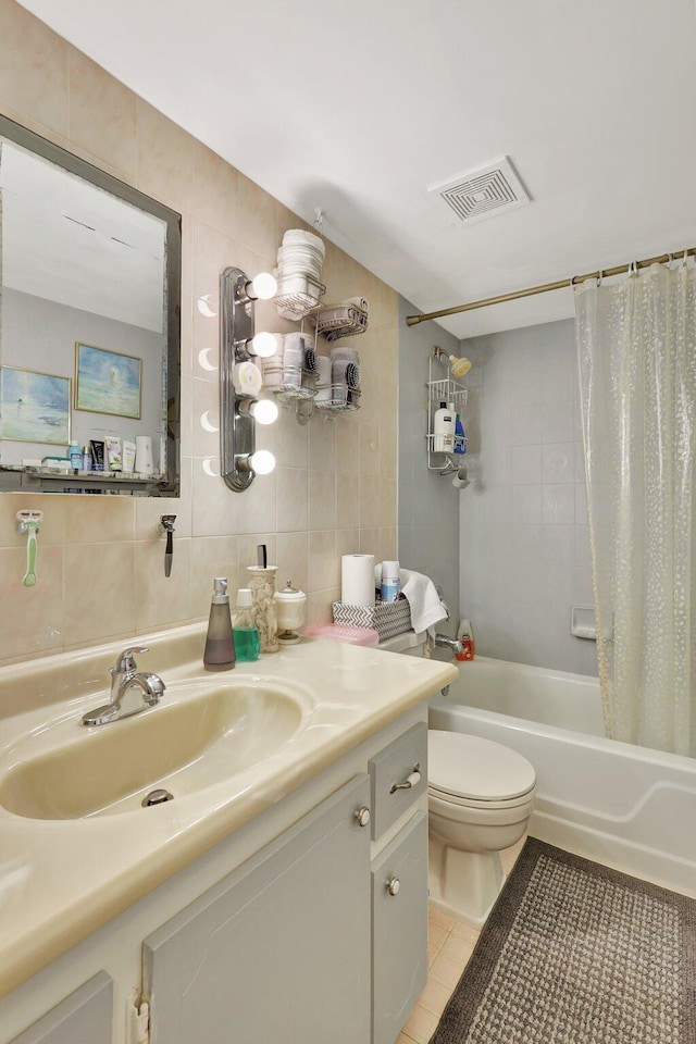 full bathroom featuring tile walls, vanity, shower / bath combo, toilet, and tile patterned floors