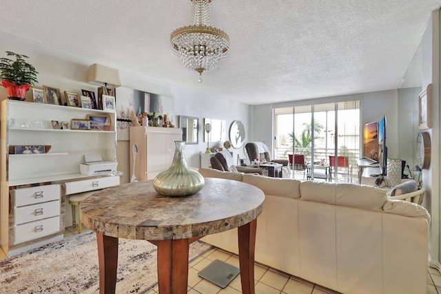 tiled living room featuring a chandelier and a textured ceiling