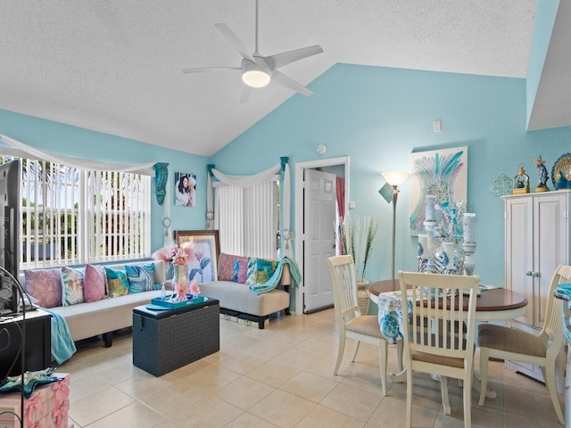 living room with a textured ceiling, light tile patterned floors, lofted ceiling, and ceiling fan