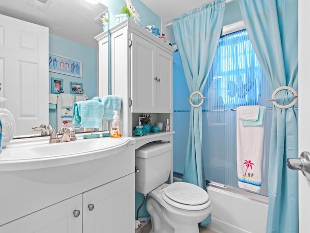 full bathroom with shower / bath combination with curtain, vanity, and toilet