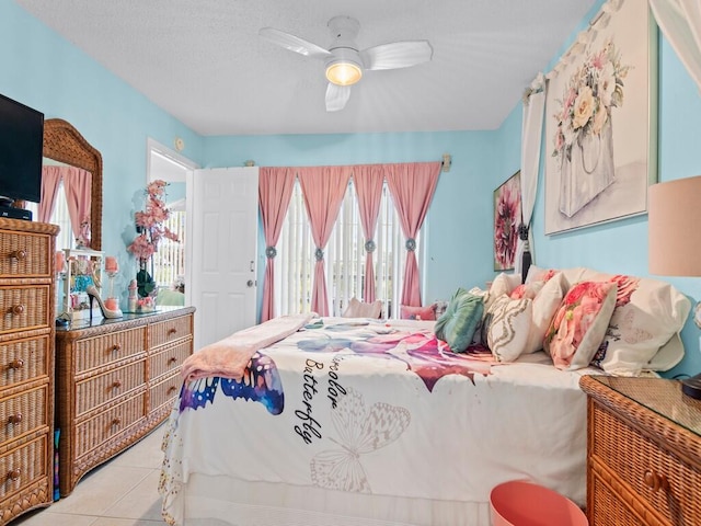 tiled bedroom featuring ceiling fan