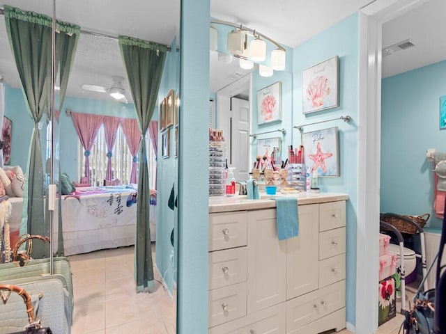 bathroom with ceiling fan, vanity, and tile patterned flooring