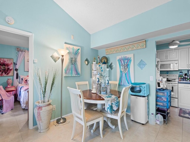 tiled dining room with vaulted ceiling