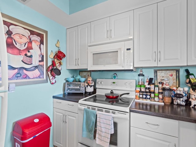 kitchen featuring white appliances and white cabinetry