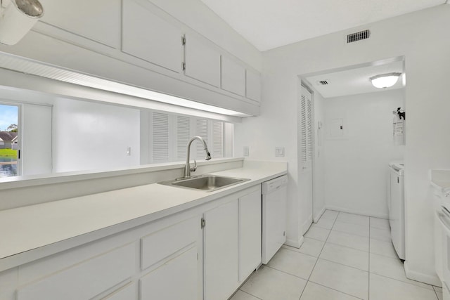 kitchen with light tile patterned floors, white appliances, and white cabinetry