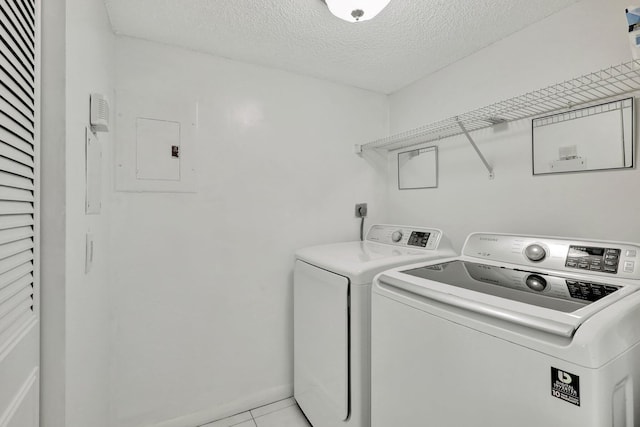 unfurnished room featuring a textured ceiling, a water view, and light tile patterned flooring