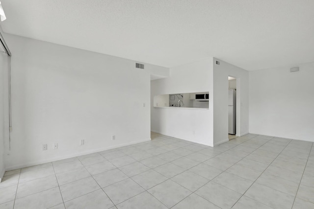 kitchen with white cabinetry, white appliances, light tile patterned floors, sink, and washer and dryer