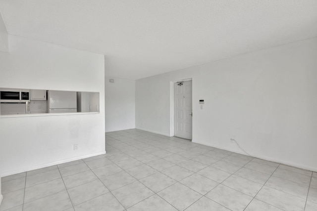 kitchen with white dishwasher, light tile patterned floors, sink, white cabinetry, and washer and clothes dryer