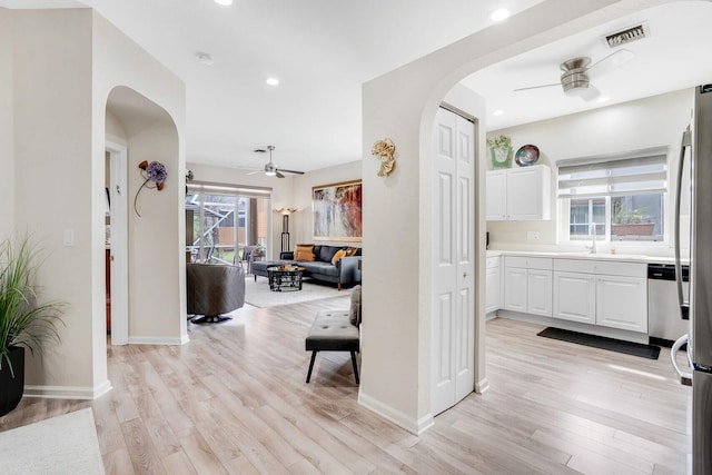 8228 Brindisi Ln, Boynton Beach, FL 33472 - hall with arched walkways, light wood-style floors, plenty of natural light, and recessed lighting