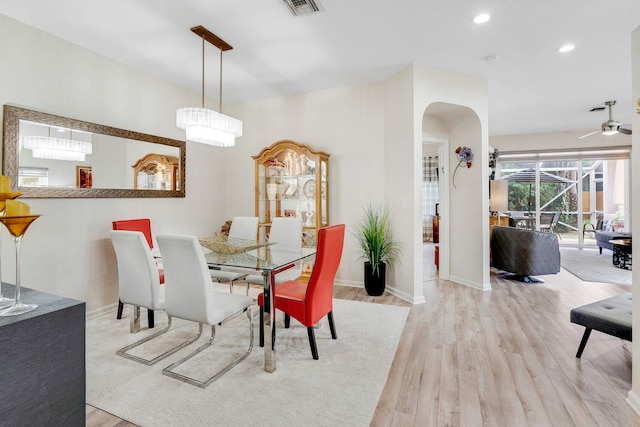 dining area with light hardwood / wood-style floors and ceiling fan