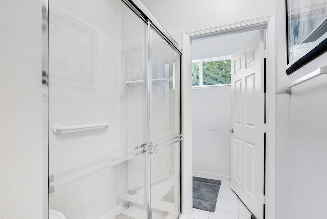 bathroom with tile patterned flooring and walk in shower