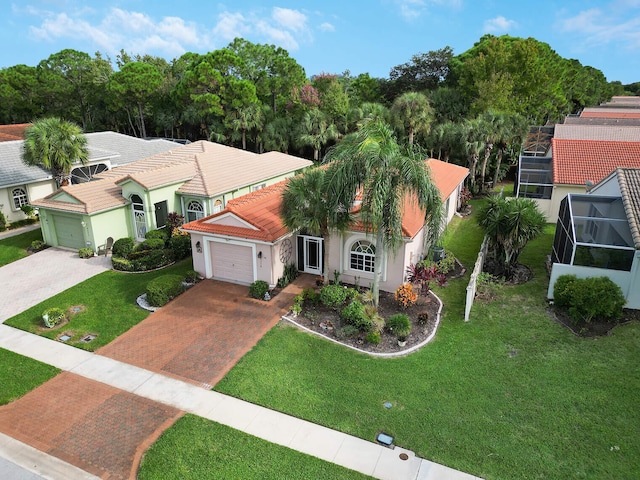8228 Brindisi Ln, Boynton Beach, FL 33472 - view of front of house with decorative driveway, a garage, stucco siding, a tiled roof, and a front lawn