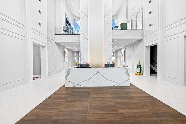 8228 Brindisi Ln, Boynton Beach, FL 33472 - reception featuring a towering ceiling, a decorative wall, stairway, and recessed lighting