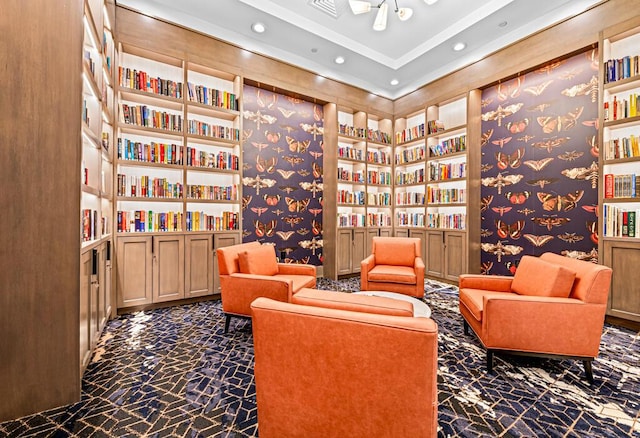 8228 Brindisi Ln, Boynton Beach, FL 33472 - sitting room with wall of books, built in features, recessed lighting, and dark marble finish flooring