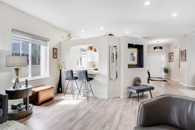 8228 Brindisi Ln, Boynton Beach, FL 33472 - living room featuring light wood-style flooring, recessed lighting, baseboards, and arched walkways