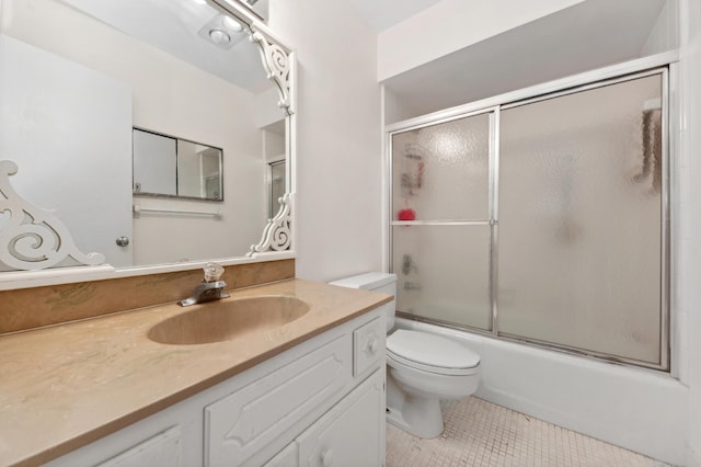 full bathroom with tile patterned flooring, vanity, toilet, and bath / shower combo with glass door