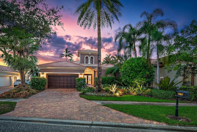 mediterranean / spanish home featuring a garage