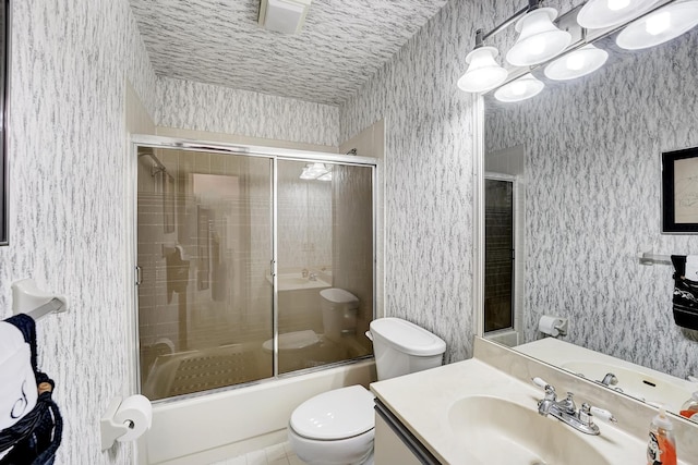 full bathroom featuring vanity, toilet, and bath / shower combo with glass door