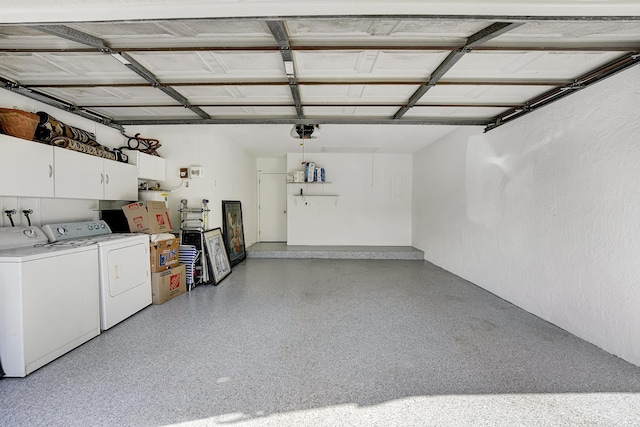 garage with a garage door opener and washer and clothes dryer