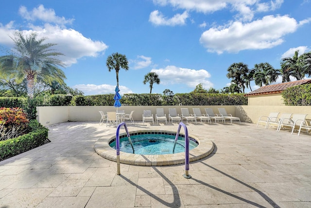 view of pool featuring a community hot tub and a patio area