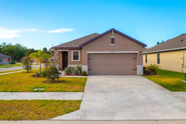 view of front of home with a front yard and a garage