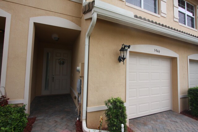 doorway to property with a garage