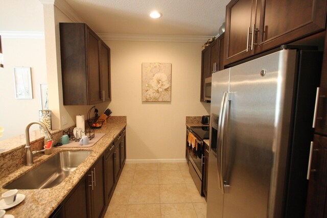 kitchen with light tile patterned floors, sink, appliances with stainless steel finishes, light stone countertops, and crown molding