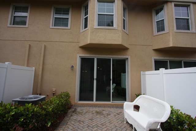 5946 Monterra Club Dr, Lake Worth, FL 33463 - rear view of property with a patio, fence, central AC, and stucco siding