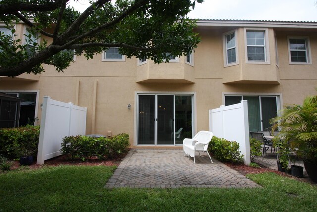 rear view of property with a patio and a yard