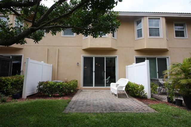 5946 Monterra Club Dr, Lake Worth, FL 33463 - back of house with a patio area, metal roof, stucco siding, and fence