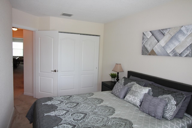 carpeted bedroom with a closet