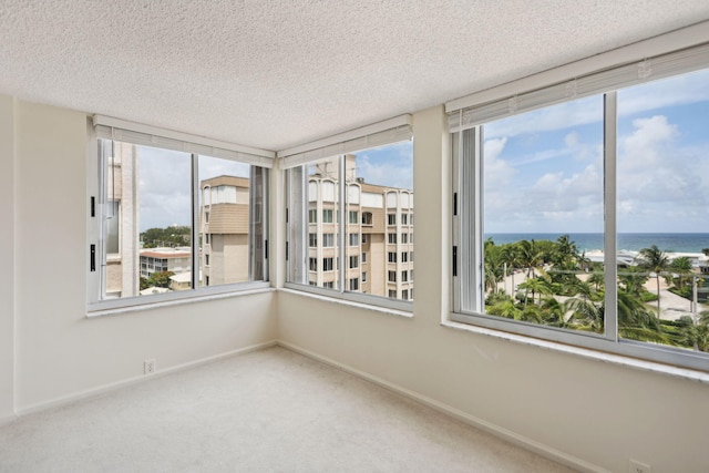 unfurnished sunroom with a water view