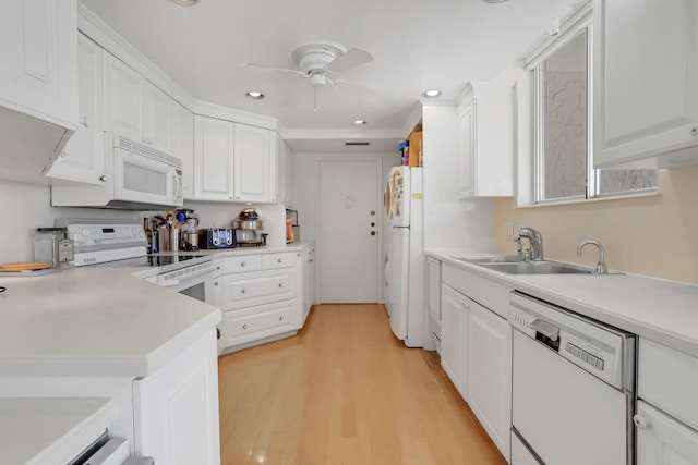 kitchen featuring sink, white cabinets, light hardwood / wood-style flooring, white appliances, and ceiling fan