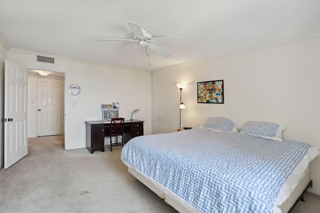 carpeted bedroom featuring ceiling fan, a textured ceiling, and ornamental molding