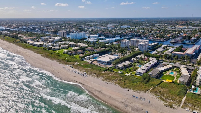 bird's eye view featuring a water view and a beach view