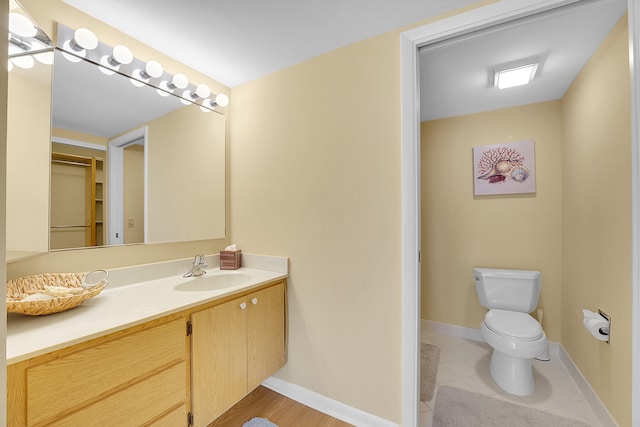 bathroom with vanity, toilet, and tile patterned floors