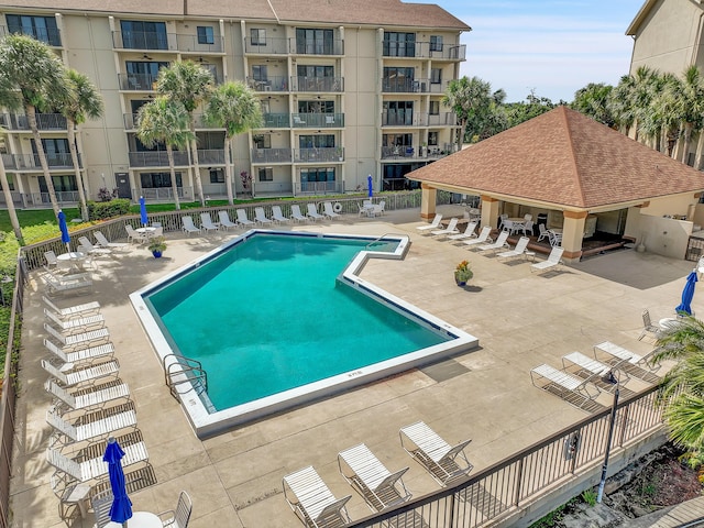community pool with a patio area and a gazebo